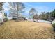 Large backyard with grassy area, mature trees, and a white fence at 259 Diamond Valley Pass, Canton, GA 30114