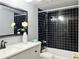 Bathroom featuring a modern vanity, black tile, and a shower-tub combo at 3125 Colonial Way # M, Atlanta, GA 30341