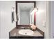 Powder room featuring a framed mirror, vanity, and gray walls at 3125 Colonial Way # M, Atlanta, GA 30341