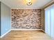 Dining room with brick accent wall and light wood flooring at 3125 Colonial Way # M, Atlanta, GA 30341