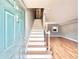 Foyer featuring new staircase, light blue front door, and hardwood floors at 3125 Colonial Way # M, Atlanta, GA 30341