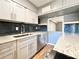 Modern kitchen features gray cabinets, stainless steel appliances, dark backsplash, and granite countertops at 3125 Colonial Way # M, Atlanta, GA 30341