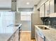 Modern kitchen features gray cabinets, stainless steel appliances, dark backsplash, and granite countertops at 3125 Colonial Way # M, Atlanta, GA 30341