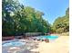 Community pool with ample lounge seating and a smaller wading pool, all set amongst lush greenery at 3125 Colonial Way # M, Atlanta, GA 30341