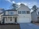 Two-story house with white siding, gray door, and attached garage at 799 River Gardens Se Dr, Atlanta, GA 30354