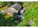 Aerial view of a brick home surrounded by lush greenery and trees at 250 Big Oak Rd, Whitesburg, GA 30185