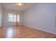 Bedroom with light blue walls, hardwood floors, and a window with neutral curtains at 250 Big Oak Rd, Whitesburg, GA 30185