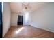 Spacious bedroom with hardwood floors, ceiling fan, and a large window at 250 Big Oak Rd, Whitesburg, GA 30185