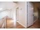 Well-lit hallway with hardwood floors and white doors leading to various rooms at 250 Big Oak Rd, Whitesburg, GA 30185