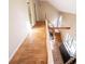 Hallway featuring hardwood floors and open staircase with natural light from windows at 250 Big Oak Rd, Whitesburg, GA 30185