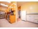 A kitchen featuring older appliances, tile floors, and yellow painted walls at 250 Big Oak Rd, Whitesburg, GA 30185