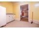 A dated kitchen with white cabinetry, an adjacent room is viewable at 250 Big Oak Rd, Whitesburg, GA 30185