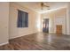 A neutral toned living room with wood-look floors, curtains, and fan at 250 Big Oak Rd, Whitesburg, GA 30185