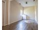 A spacious room with light walls, wood look floors, and two entry doors at 250 Big Oak Rd, Whitesburg, GA 30185