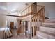 An open staircase with wood railings and floors under skylight at 250 Big Oak Rd, Whitesburg, GA 30185