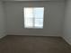 Simple bedroom with carpet and a window with blinds at 6745 Trafalger Sq, Norcross, GA 30093