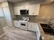 White kitchen with granite countertops and stainless steel appliances at 6745 Trafalger Sq, Norcross, GA 30093