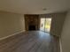 Living room with stone fireplace and sliding glass door to patio at 6745 Trafalger Sq, Norcross, GA 30093