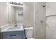 Bathroom with a toilet, vanity with modern fixtures and a tiled shower at 2502 Park Dr, Lithonia, GA 30058