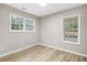 Bedroom featuring two windows and wood flooring at 2502 Park Dr, Lithonia, GA 30058