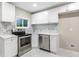 Close-up of a stylish kitchen boasting stainless steel appliances and modern white countertops at 2502 Park Dr, Lithonia, GA 30058