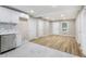 Bright living room featuring white cabinets, stainless steel appliances, and luxury vinyl flooring at 2502 Park Dr, Lithonia, GA 30058