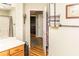 Bright bathroom with modern fixtures showcases wood-look flooring leading to additional rooms at 101 Emily Ln, Carrollton, GA 30116