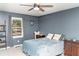 Cozy bedroom with blue walls, carpet floors, and a window with curtains at 101 Emily Ln, Carrollton, GA 30116