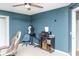 Bedroom with ceiling fan, blue accent wall, neutral carpet, and useful storage at 101 Emily Ln, Carrollton, GA 30116