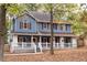 Two-story house with wrap around porch, shutters and landscaping at 101 Emily Ln, Carrollton, GA 30116