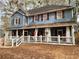 Two-story house with wrap around porch, shutters and landscaping at 101 Emily Ln, Carrollton, GA 30116