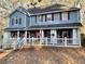 Two-story house with a wraparound porch and gray siding at 101 Emily Ln, Carrollton, GA 30116