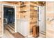 Hallway featuring wood paneling, white cabinets and access to the bar and bathroom at 101 Emily Ln, Carrollton, GA 30116