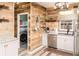 Laundry room with wood plank walls, granite counters, and stainless steel appliances at 101 Emily Ln, Carrollton, GA 30116