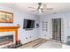 Living room with fireplace, TV, and ceiling fan at 101 Emily Ln, Carrollton, GA 30116