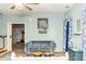 Cozy living room featuring a plush grey couch, decorative art, and wood accents at 101 Emily Ln, Carrollton, GA 30116