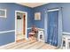 Sitting room featuring blue walls, modern wood floors, and decorative wall trim at 101 Emily Ln, Carrollton, GA 30116