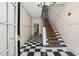 Elegant entryway featuring a black-and-white tiled floor and carpeted staircase leading to upper levels at 242 12Th Ne St # 14, Atlanta, GA 30309