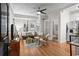 Cozy living room with hardwood floors, neutral decor, and a view into a tiled bathroom and compact kitchen at 242 12Th Ne St # 14, Atlanta, GA 30309