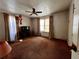 A carpeted bedroom with two windows with curtains, a ceiling fan, and a desk at 1907 Grandview Se Cir, Atlanta, GA 30316