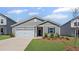 Charming single-story home showcasing a manicured lawn and attached garage on a sunny day at 3087 Birdsong Ave, Covington, GA 30016