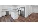 Modern kitchen with white cabinets, stainless steel appliances, and a granite island at 3087 Birdsong Ave, Covington, GA 30016
