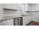 Bright kitchen featuring granite counters, stainless steel dishwasher, and subway tile backsplash at 3087 Birdsong Ave, Covington, GA 30016