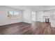 Bright living room with wood-look flooring, connecting to the kitchen, and bathed in natural light at 3087 Birdsong Ave, Covington, GA 30016