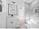 Bathroom featuring modern fixtures, a marble floor, and a stylish vanity with a large mirror at 1387 Mineral Springs Rd, Hoschton, GA 30548