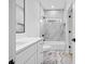 Modern bathroom featuring marble floors, a white vanity, and a shower-tub combo with gray tiled walls at 1387 Mineral Springs Rd, Hoschton, GA 30548