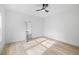 Bright, airy bedroom featuring light hardwood floors, an open doorway, and lots of natural light at 1387 Mineral Springs Rd, Hoschton, GA 30548