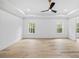Large bedroom with hardwood floors, bright natural light, and detailed ceiling trim at 1387 Mineral Springs Rd, Hoschton, GA 30548