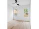 Bright bedroom with ceiling fan, light hardwood floors, and large windows at 1387 Mineral Springs Rd, Hoschton, GA 30548