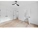 Bright bedroom with light hardwood floors, a ceiling fan, and access to an ensuite bathroom at 1387 Mineral Springs Rd, Hoschton, GA 30548